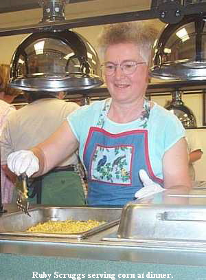 Ruby Scruggs serving corn at dinner.