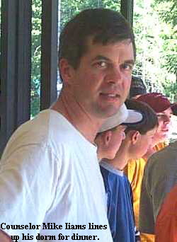 Counselor Mike Iiams lines
 up his dorm for dinner.